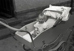 A young baby in a fine pram