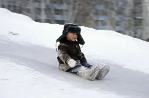 Frozen Prints: Young boy does downhill-ice-sliding just on his