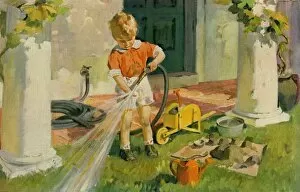 Images Dated 22nd November 2011: Young boy with garden hose