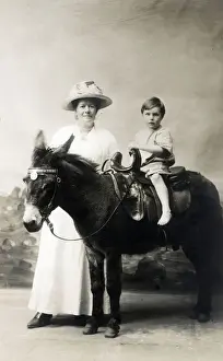 Young Boy and his Mother - Studio photo on a donkey