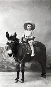Dec19 Collection: Young Boy in Summer attire - Studio photo on a donkey