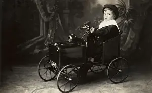 Young boy in toy car