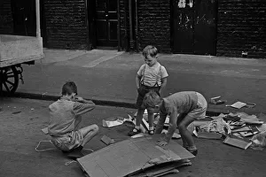 Three young boys playing in street, London