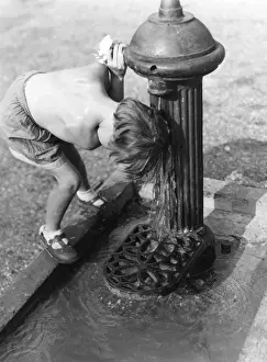 Young child with head under hydrant