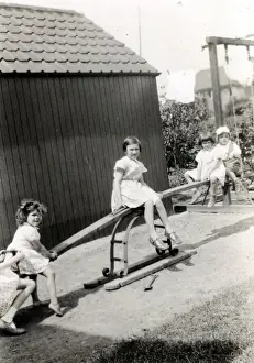 Playground Prints: Four young children playing on a see-saw