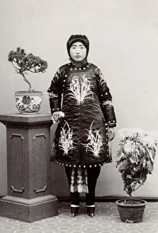 Young Chunese woman, ornate robe, bound feet, China