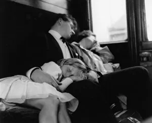 Images Dated 26th May 2017: Young couple and child sleeping in a train compartment