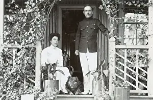 Young couple and a dog on a garden porch
