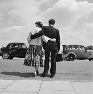 Young couple standing with arms around each other