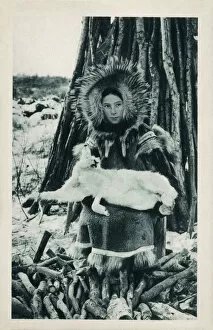 Images Dated 4th April 2019: Young Eskimo (Inuit) girl with a captured Arctic Hare