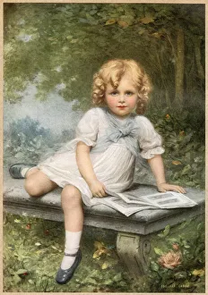 Images Dated 17th June 2021: A young girl with blonde curls sits with her picture book on a stone bench in a woodland