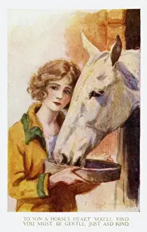 Young girl feeding horse
