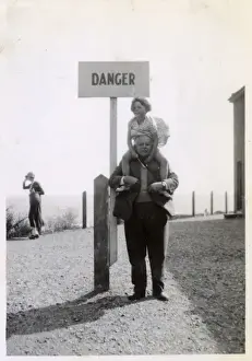Hilarious Prints: Young girl on Grandfathers shoulders by Danger sign