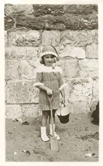 Images Dated 1st August 2017: Young girl in remarkable woollen ensemble on beach