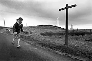 Signpost Prints: Young girl rollerskating past Sirhowy Valley Walk sign