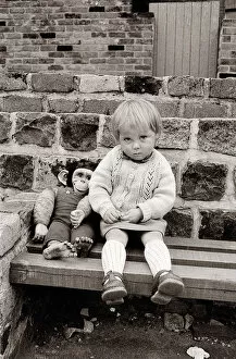Images Dated 10th November 2015: A young girl with a toy monkey in Eccles