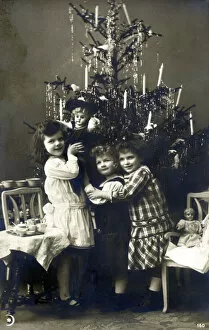 Three young Italian sisters by their Christmas Tree