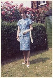 Young lady in a smart two-piece blue and white summer outfit