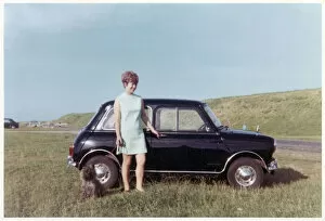 Young lady, terrier and Mini Cooper car