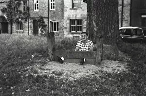 Stocks Collection: Young man fools about in The Stocks