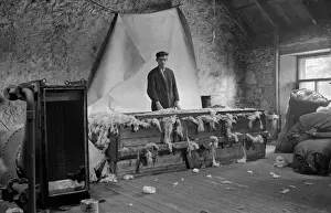 Floorboards Prints: Young man processing wool, Scotland