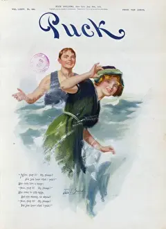 Young man splashing a young woman with water at the beach