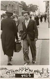 Candid Prints: Young man with surly expression - candid street photograph