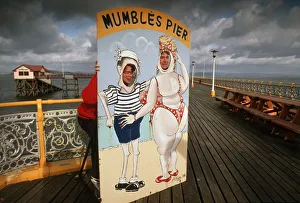 Images Dated 27th August 2019: Two young men put their heads through a comic cartoon cutout