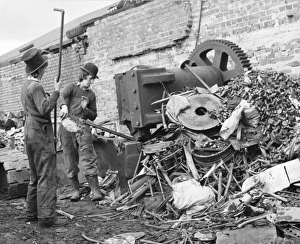 Hats Gallery: Two young men sorting through a pile of scrap metal