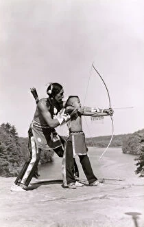 Shooting Collection: Young Native American Indian boy learning to shoot his bow