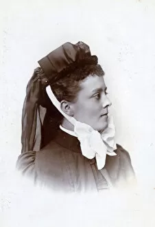 Images Dated 5th November 2018: Young nurse with bonnet tied on with fancy white ribbon