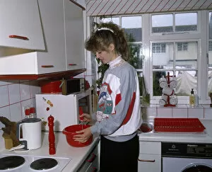 Mixing Gallery: Young woman cooking in a kitchen