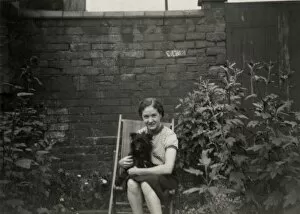 Images Dated 8th November 2011: Young woman in deckchair with dog