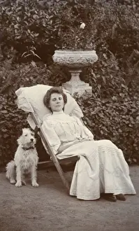 Young woman and dog in a garden