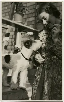 Young woman with a dog in a back garden
