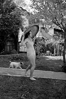 Images Dated 27th April 2021: Young woman and dog in a garden