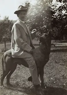 Young woman on dog statue in a garden