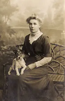 Young woman with dog in studio photo