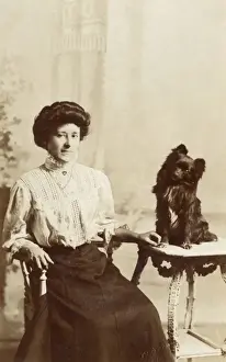 Lapdog Prints: Young woman with dog in studio photo