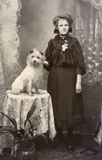 Young woman with dog in studio photo