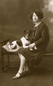 Young woman with dog in studio photo