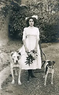 Young woman with two dogs in a garden