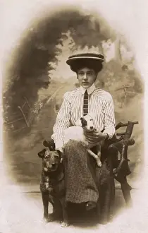 Young woman with two dogs in studio photo