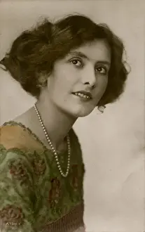 Young woman in green dress and pearl necklace
