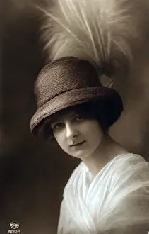 Young woman in hat with feather