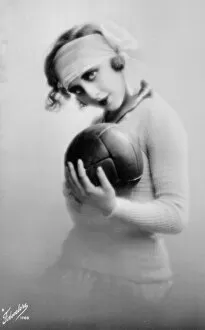 Seductive Gallery: Young woman holding a football