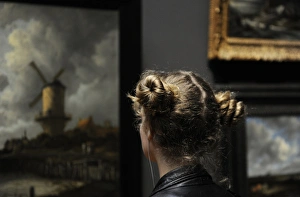 Admire Gallery: Young woman looking the painting The Windmill at Wijk bij Du