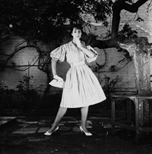 Images Dated 5th February 2016: Young woman modelling a dress in a garden