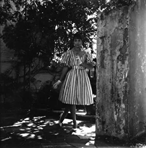 Images Dated 5th February 2016: Young woman modelling a dress in a garden