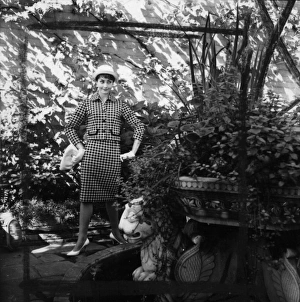 Images Dated 5th February 2016: Young woman modelling a suit in a garden